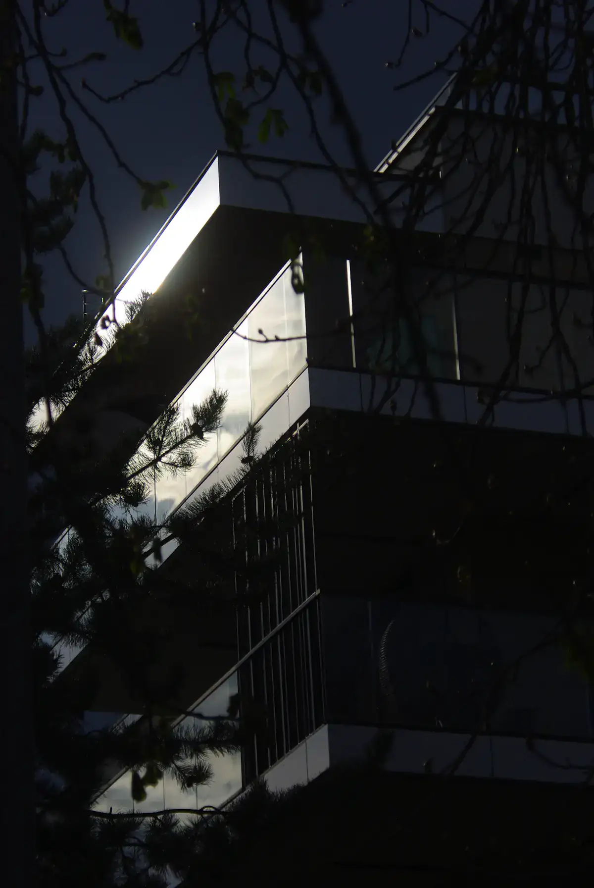 Modern glass office building reflecting the sky; illustrative architecture photograph