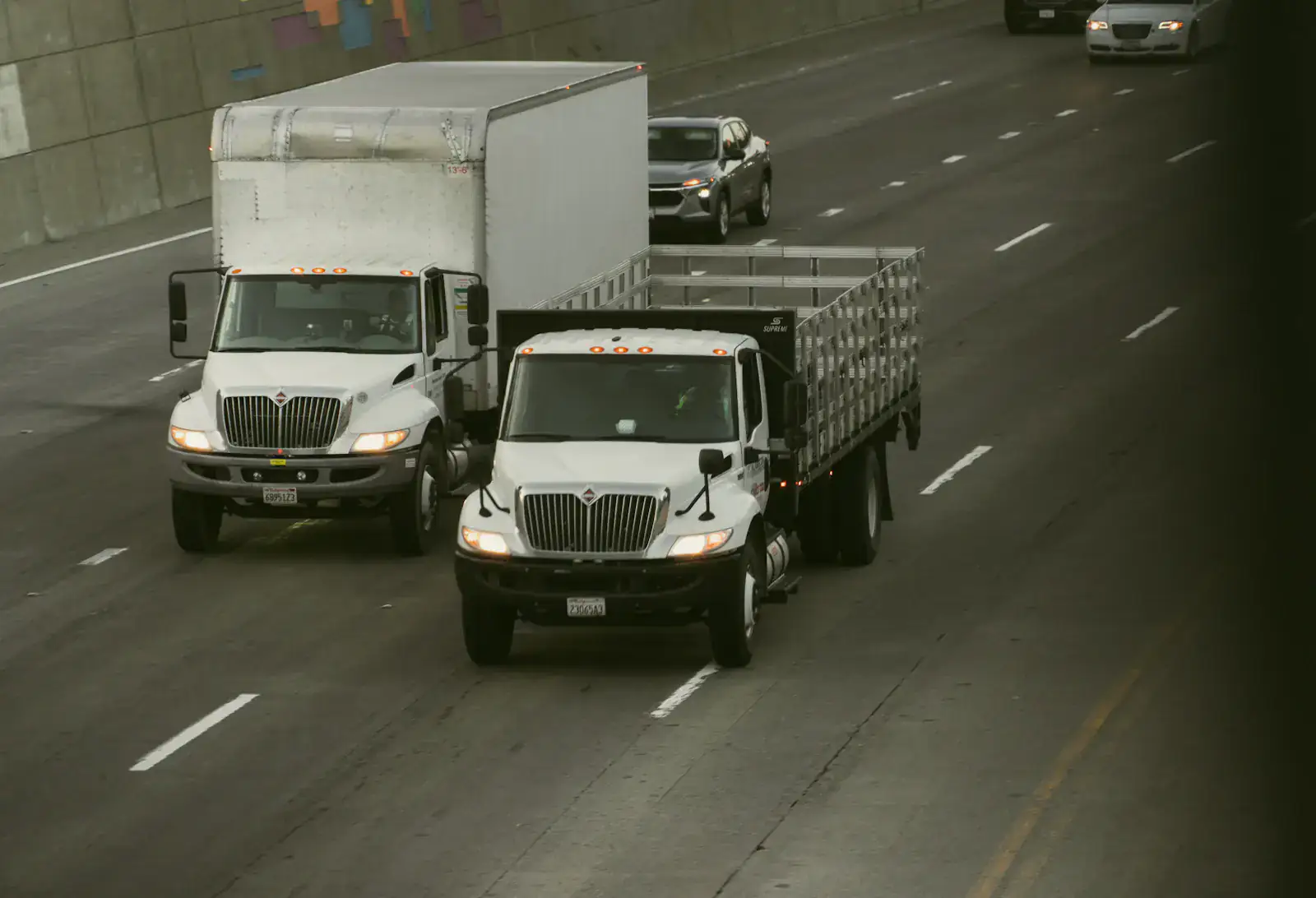 Commercial trucks travelling on a divided highway, illustrating fleet operations