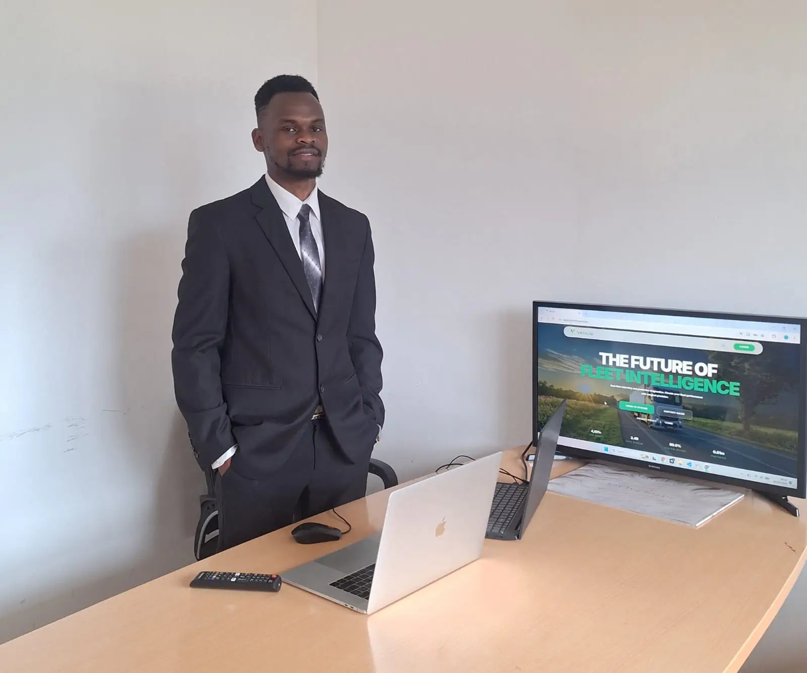 Keith Adede, Founder and CEO, beside a monitor displaying Venus